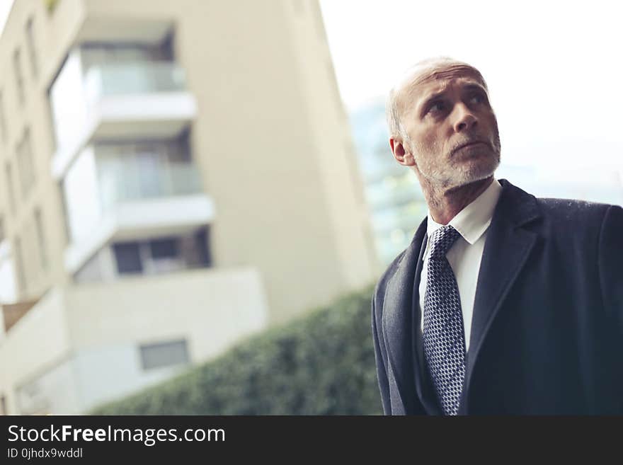 Photo of Old Man Wearing Formal Coat