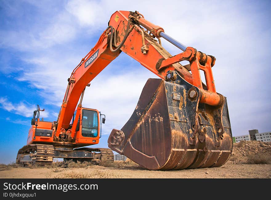 Red Excavator Under the Blue Sky