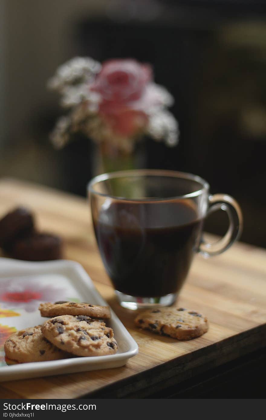 Glass Teacup Beside a Cookies on Tray Placed on Table