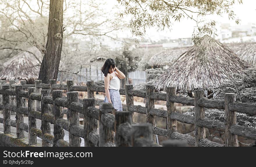 Woman Standing on Gray Bridge