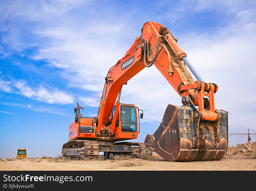 Red Excavator on Dry Field