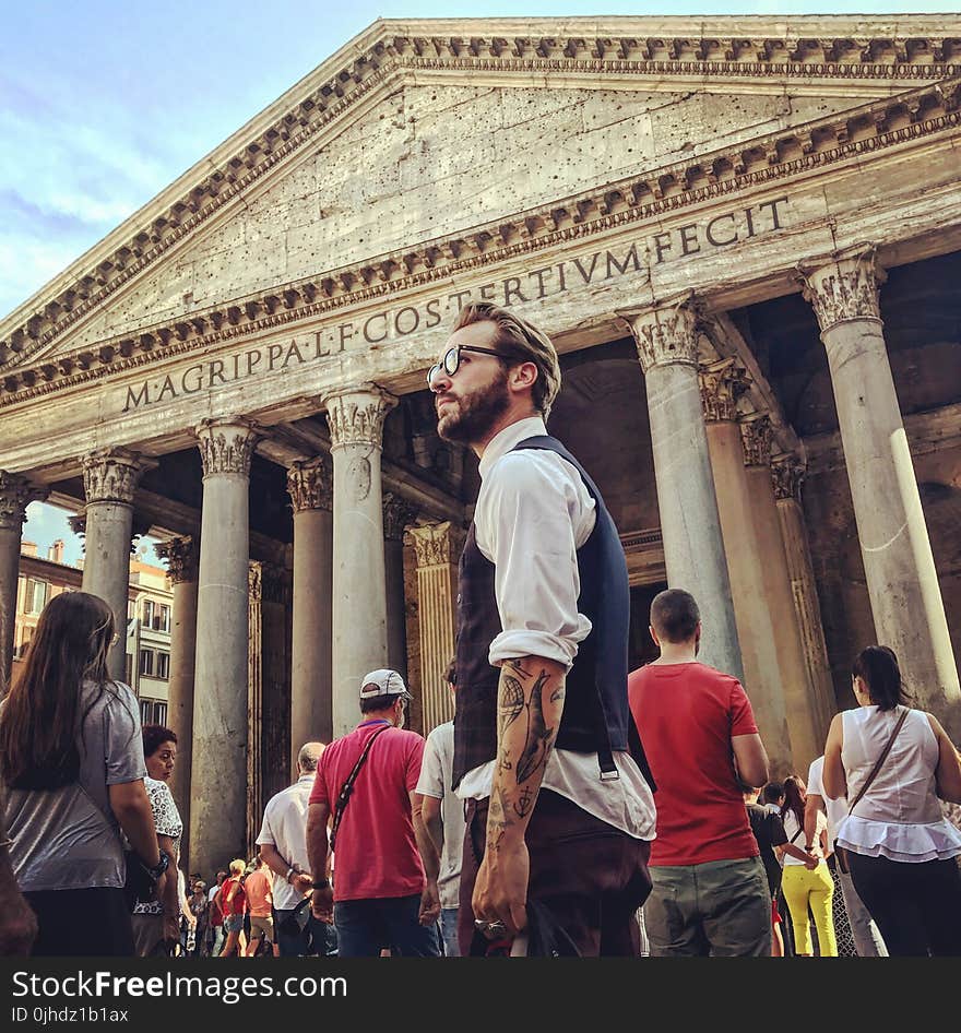 Man in Blue Waistcoat and White Dress Shirt Standing Near Magrippa Lf Costertivm Fecit Temple Behind Crowd of People