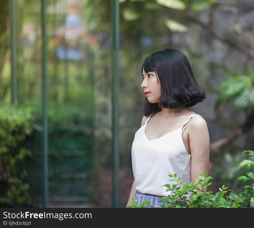 Black Haired Woman in White Spaghetti Strap Top