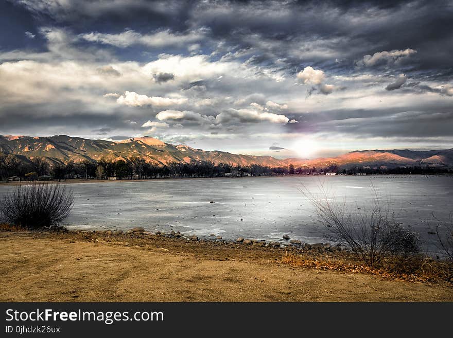 Landscape Photography of Mountains Near Body of Water