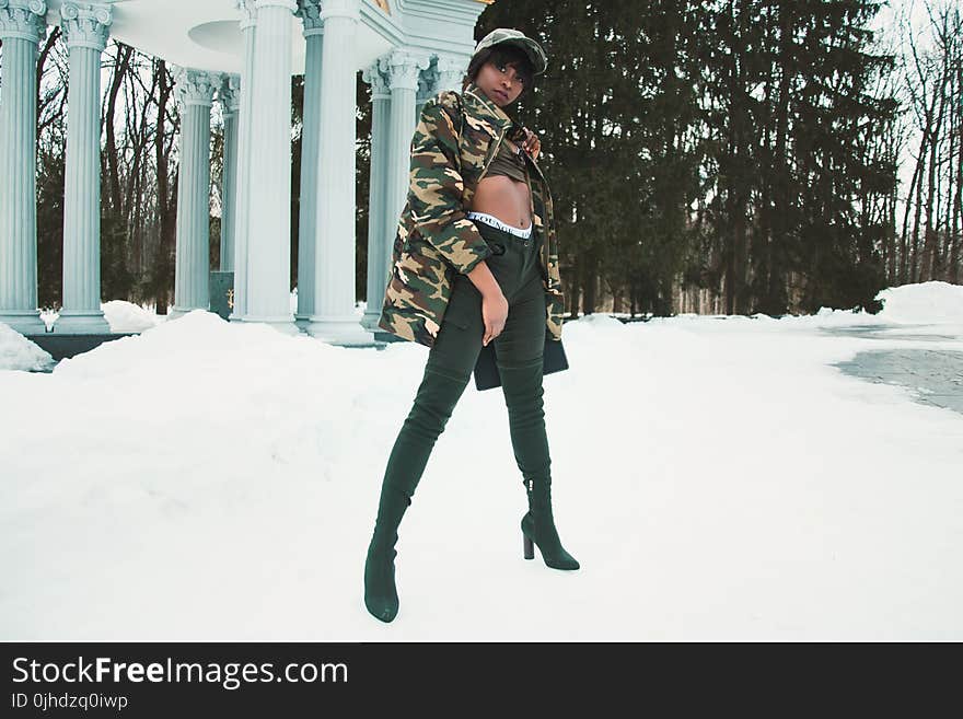 Woman Wearing Camouflage Jacket Standing on Snow