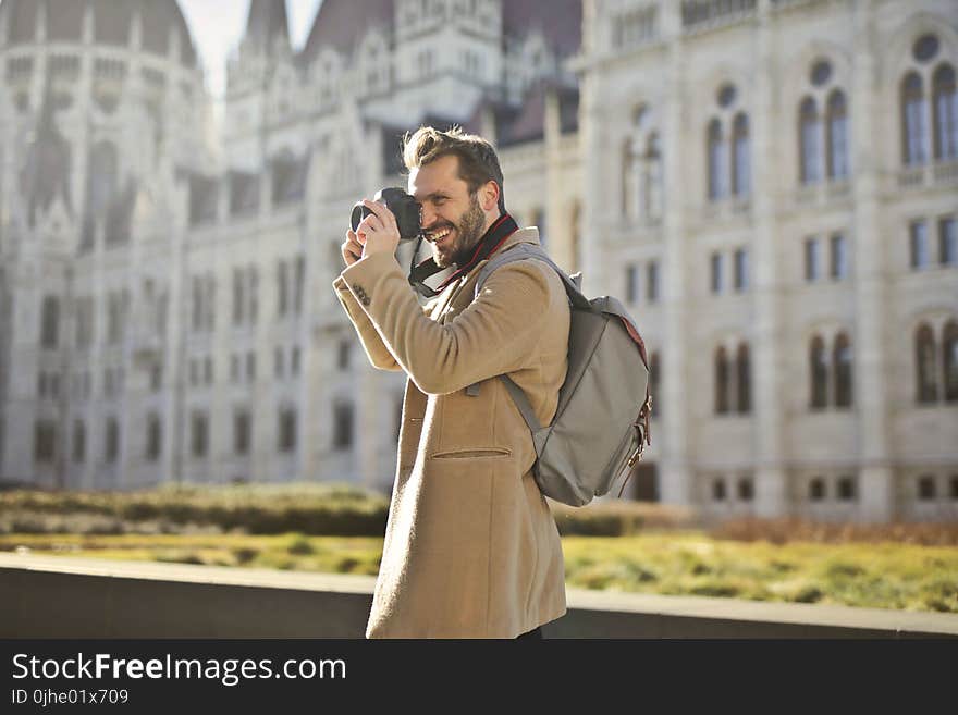 Man Holding and Capturing Images Around Him