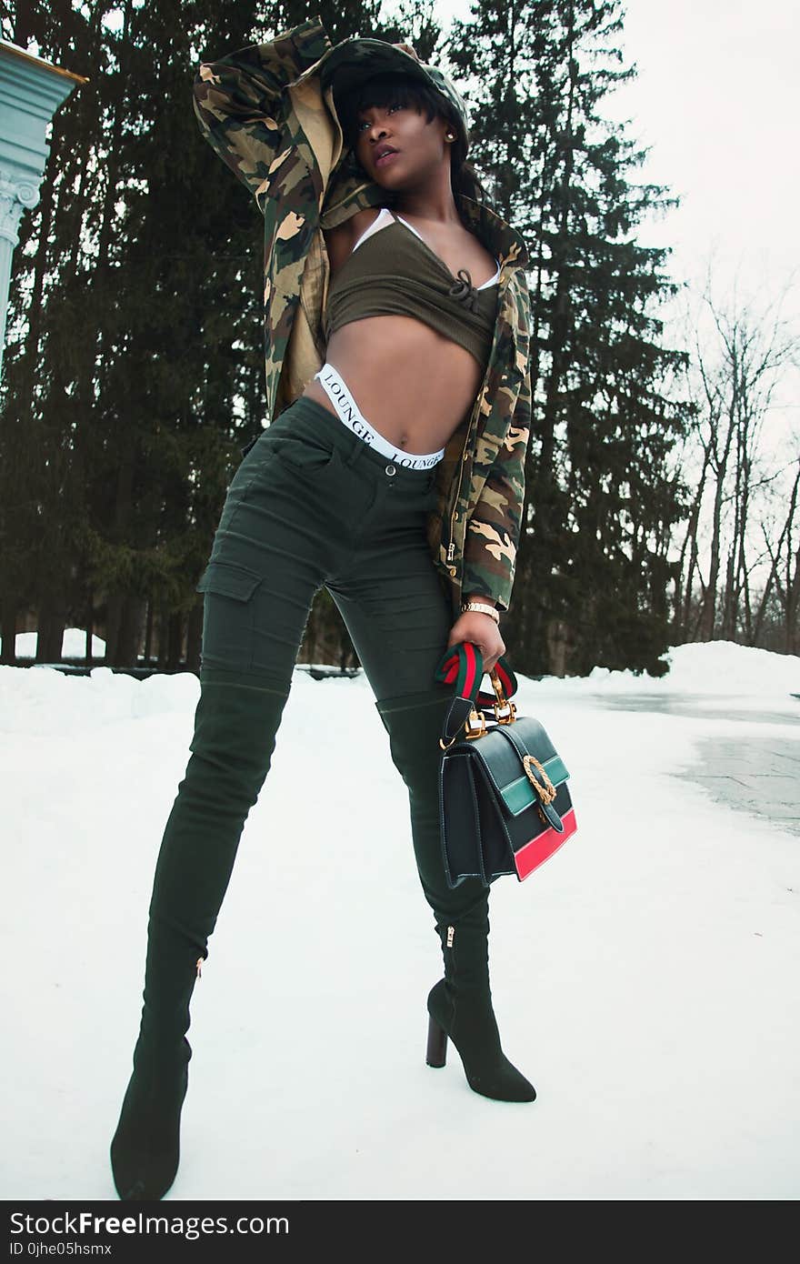 Woman Wearing Black Sports Bra While Holding Handbag