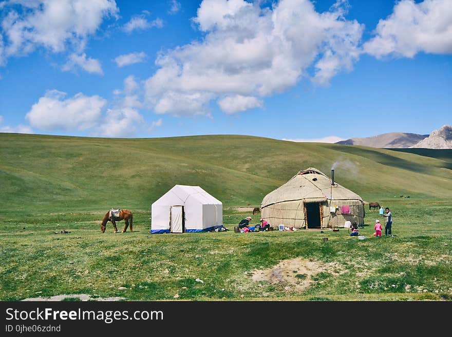 Photo of Hut And Tent On Grass Field