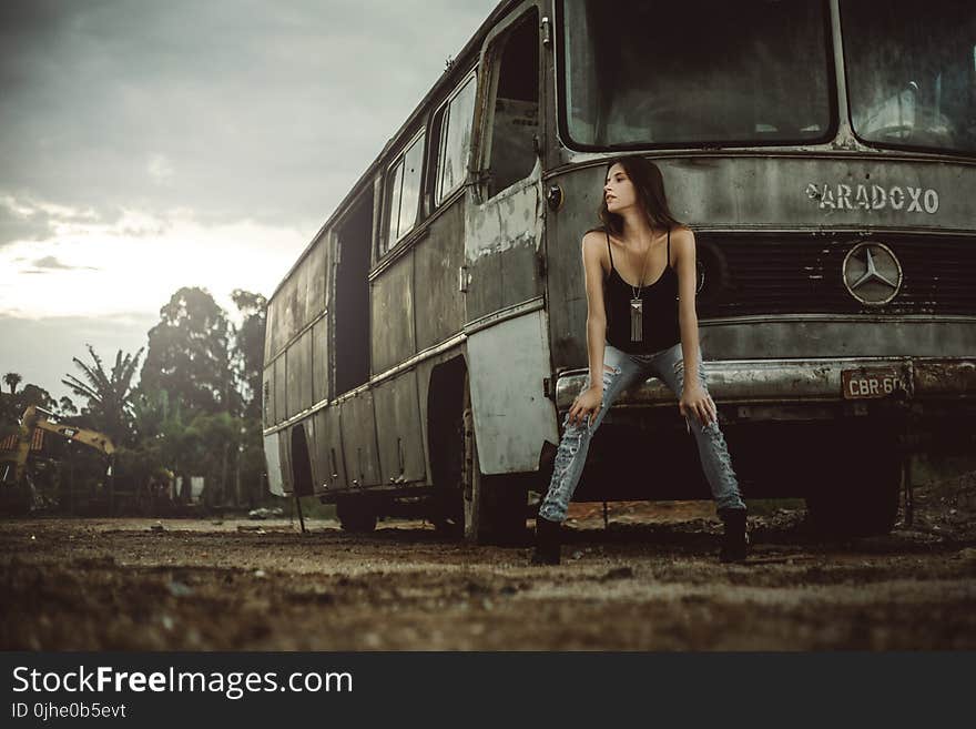 Woman Sitting in Front of Bus