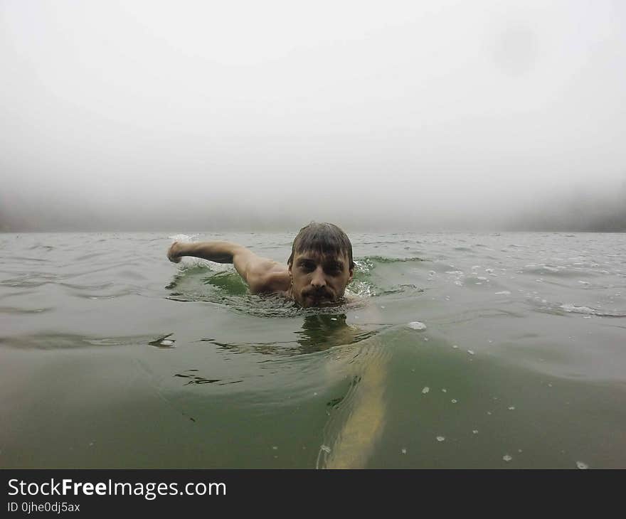 Man Taking a Photo of Her in the Ocean