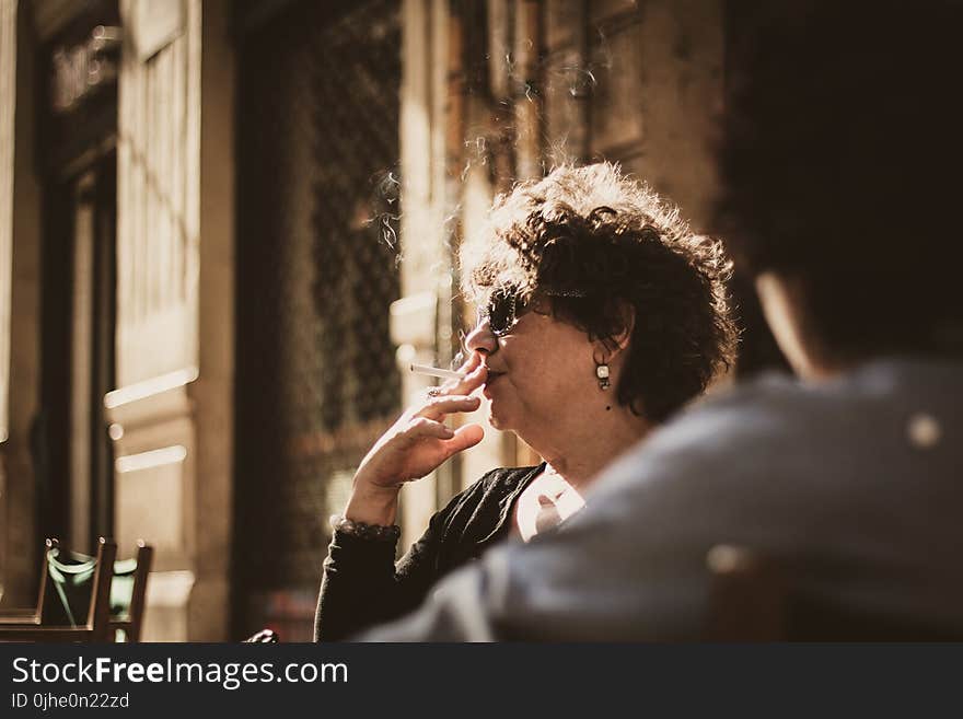 Photography of a Woman Smoking Cigarette