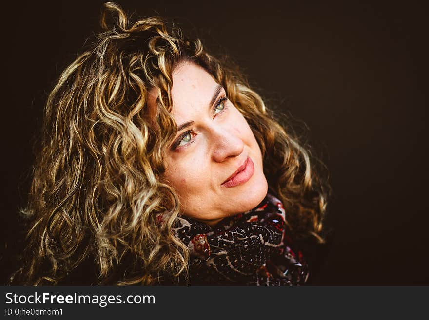 Close-Up Photography of Woman Wearing Red and Black Scarf