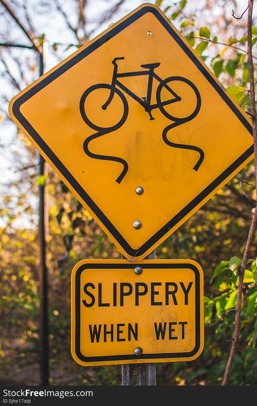 Yellow and Black Slippery When Wet Road Sign Board