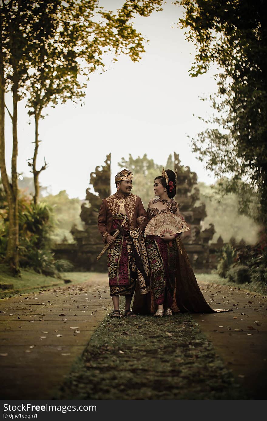 Man and Woman in Traditional Clothing Near Angkor Wat