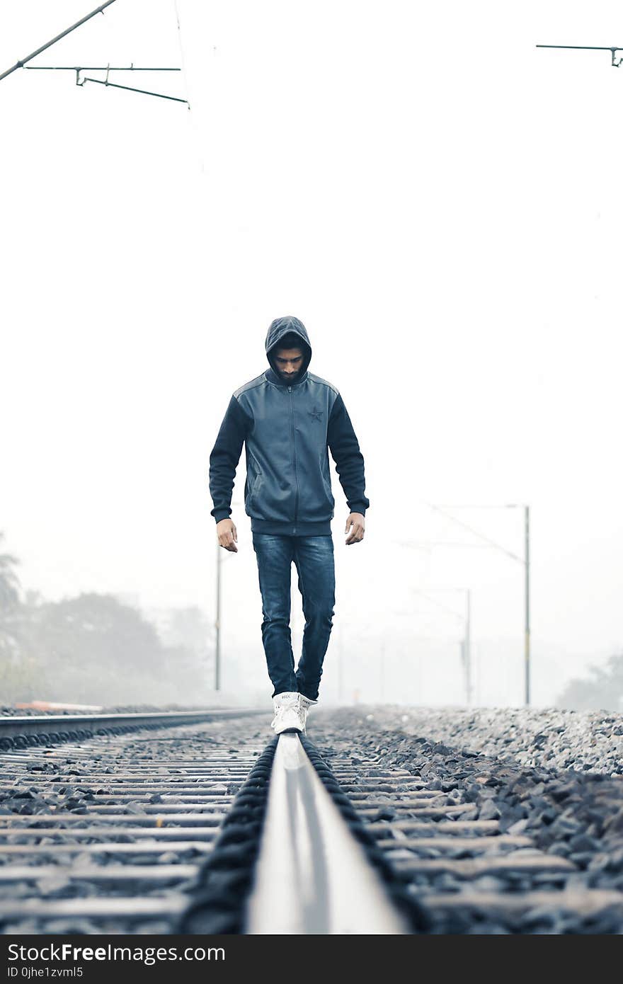 Man Walking on Train Rail