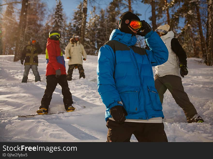 Group of People in Bubble Jackets Skiing in Mountain