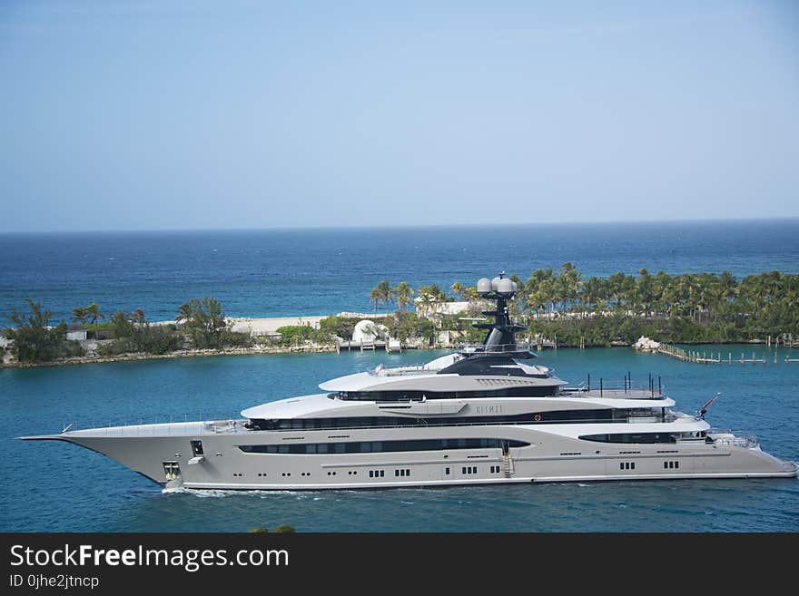 White and Blue Yacht on Body of Water