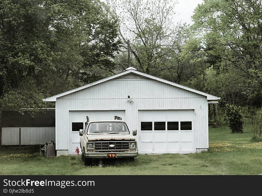 Classic White Chevrolet Pickup Truck Near White 2-door Garage Near Trees