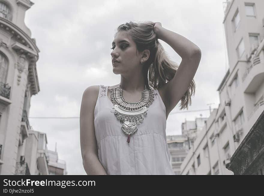 Woman Wearing White Tank Top Holding Hair Pose