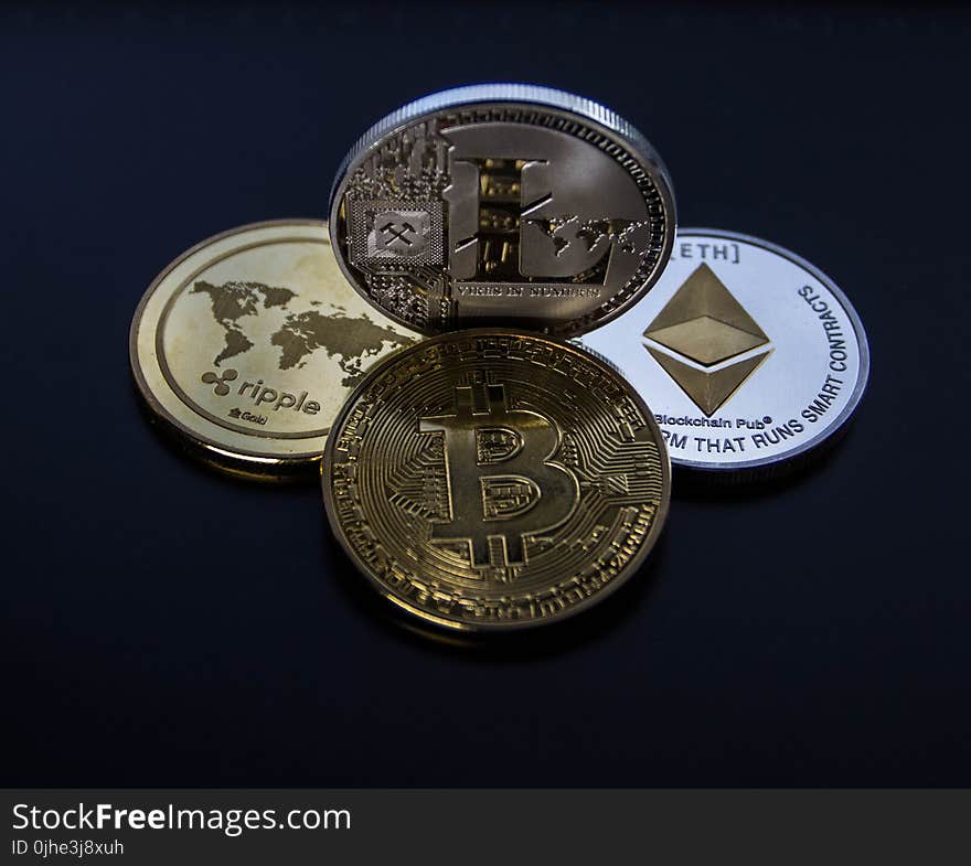 Four Assorted Cryptocurrency Coins