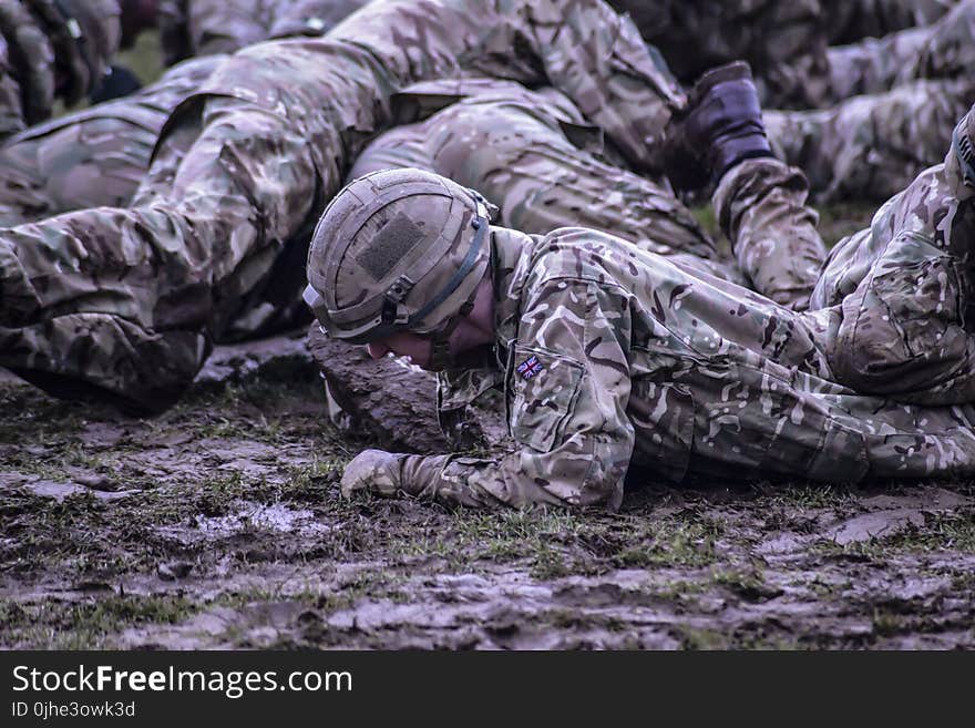 Group of Soldiers Crawling on Mud