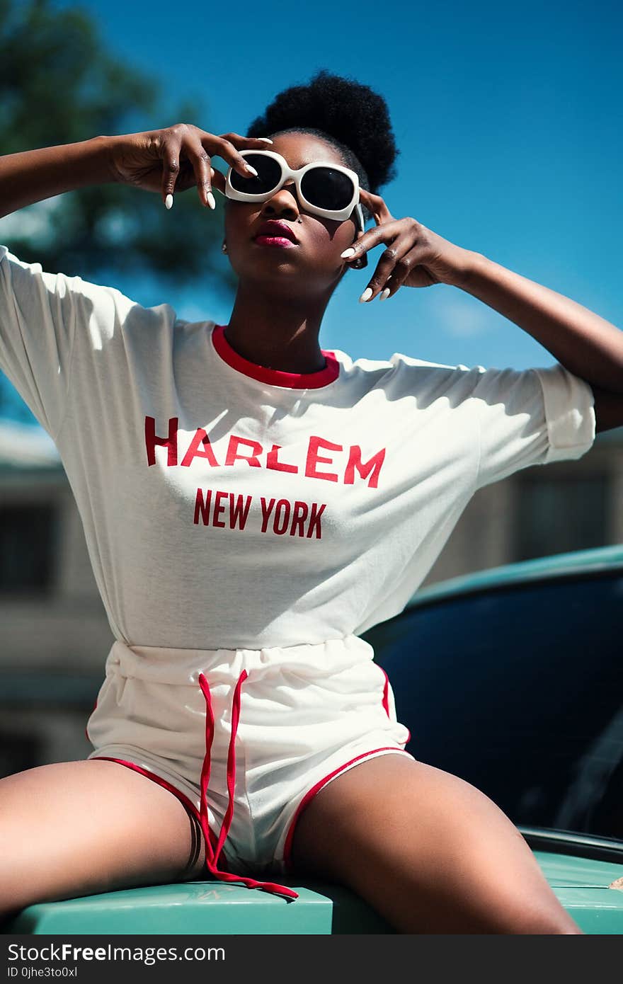 Woman Wearing White and Red Harlem New York Printed Round-neck Batwing-sleeved Shirt With Drawstring Dolphin Shorts