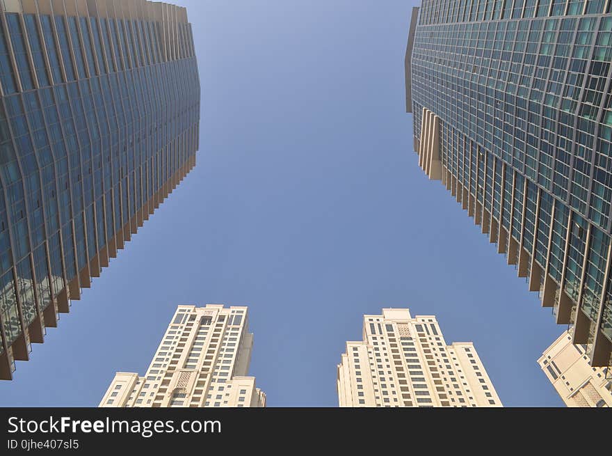 Two Gray-and-blue Glass Buildings