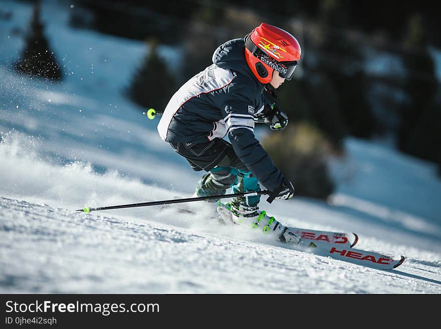 Man Doing Ice Skiing on Snow Field in Shallow Focus Photography