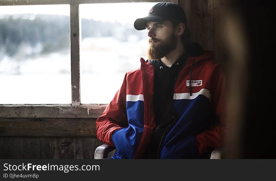 Man Wearing Blue, Red, and White Jacket