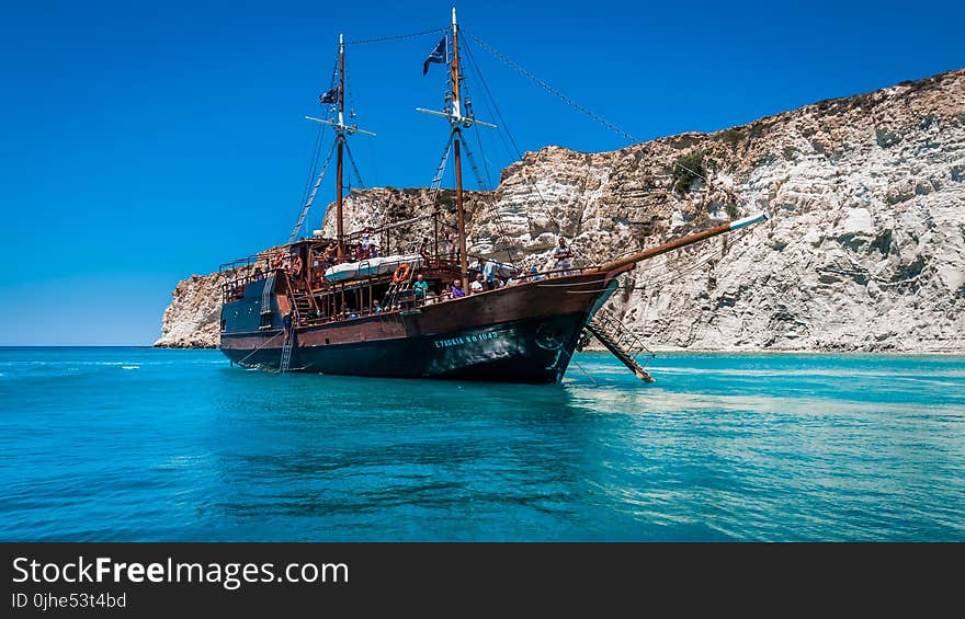 Brown Ship on Body of Water