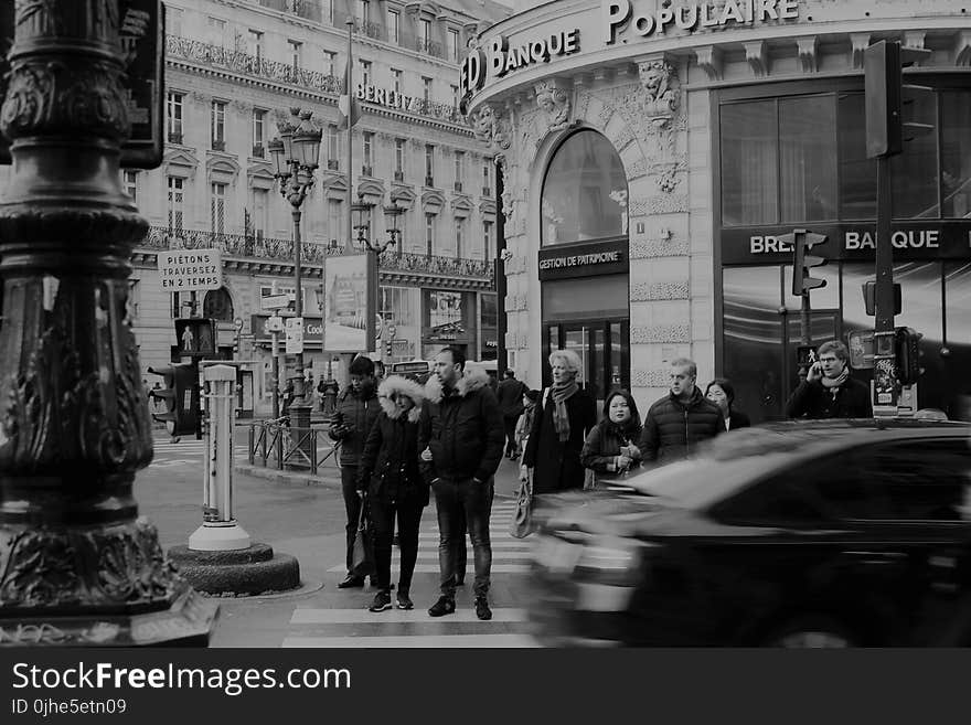 Grayscale Photography of Man Crossing Road