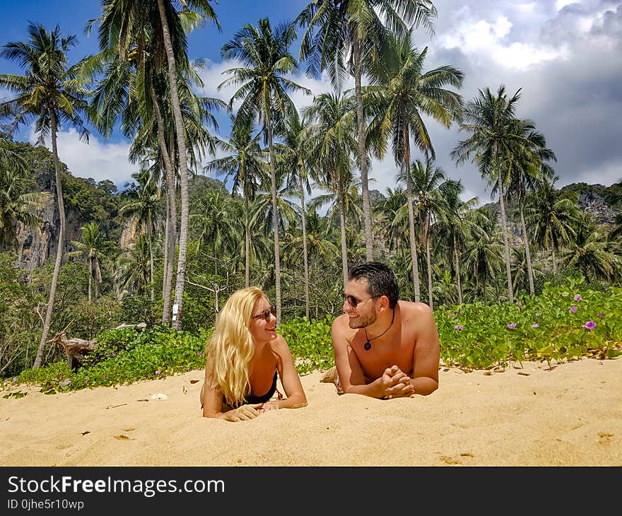 Man and Woman Lying on Sand