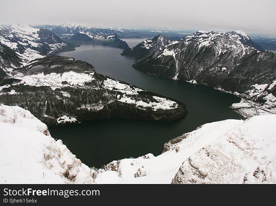 Islands With Snow Near Body of Water