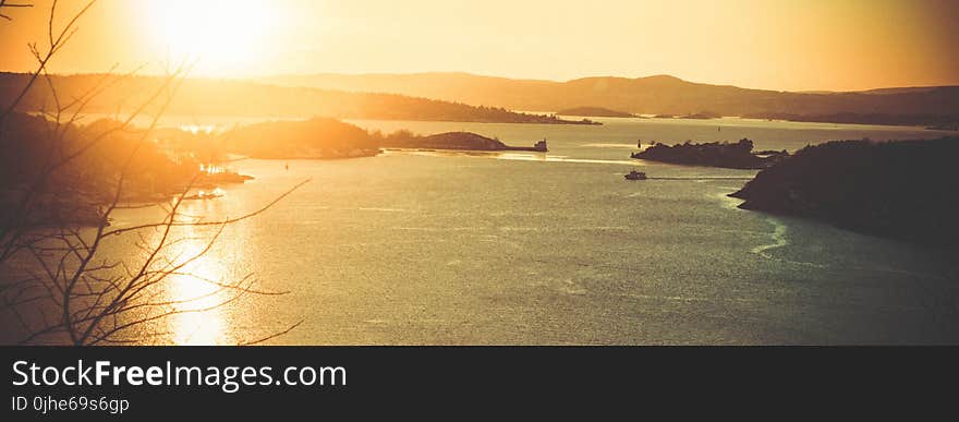 Silhouette Photo of Body of Water during Sunset