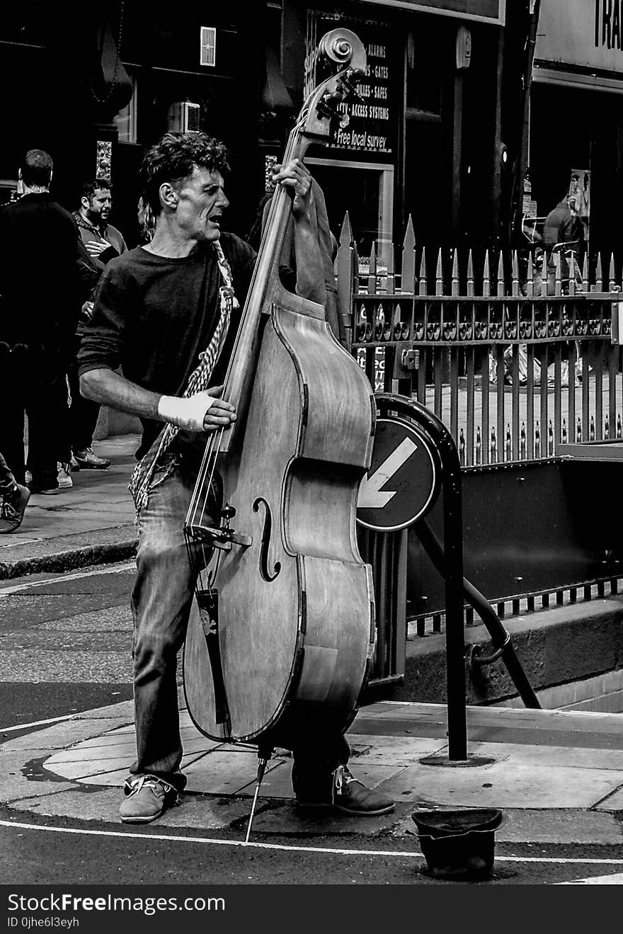 Grayscale Photography of Man Playing Cello