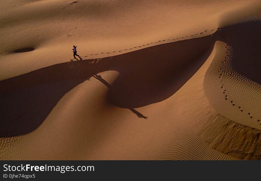 Person Walking on Desert