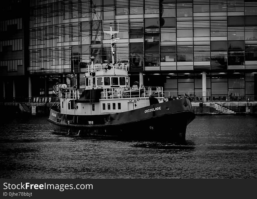 Grayscale Photo of Ship Near Building