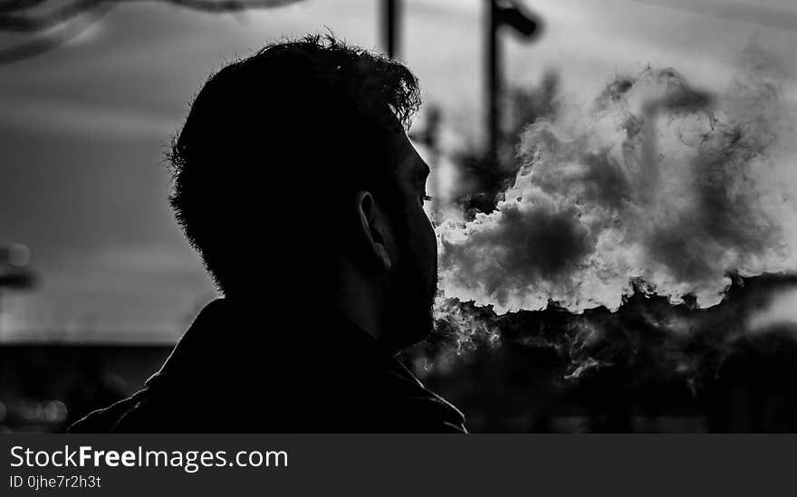 Grayscale Photography of Man Smoking