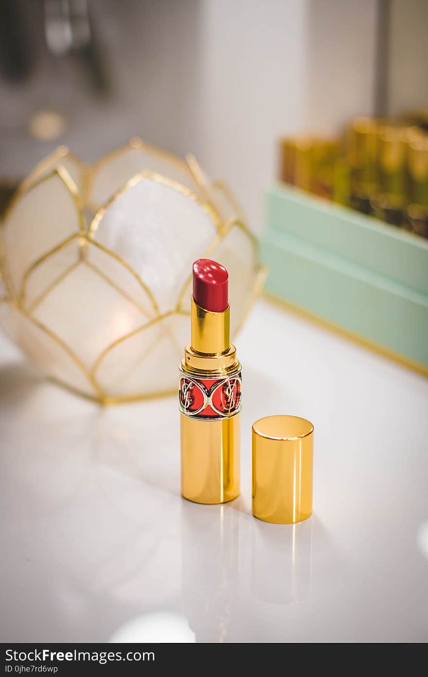 Close-Up Photography of Red Lipstick on Desk