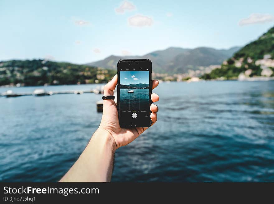 Person Holding Space Gray Iphone 5s Taking Picture of Beach