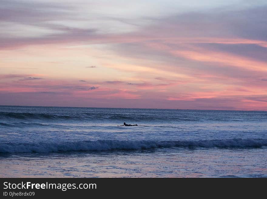 Panoramic Photography of Surfing Man at Sunset