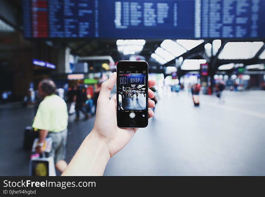 Person Holding Space Gray Iphone 5s on Camera Application