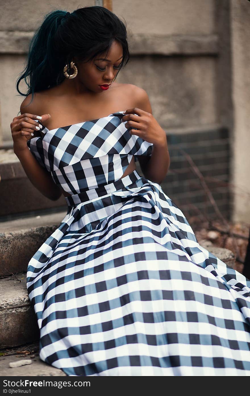 Woman Wearing Strapless Dress Sitting on Staircase