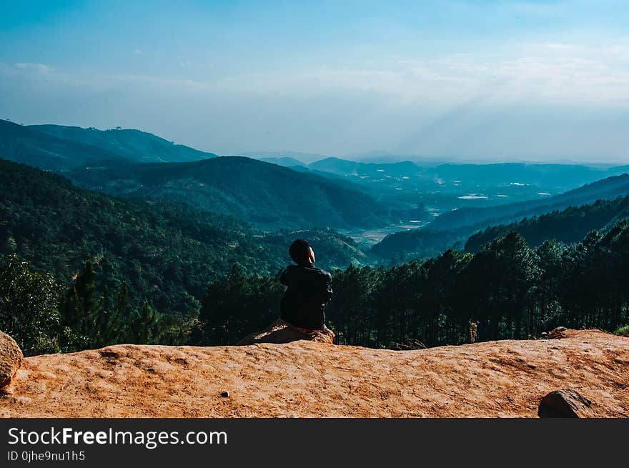 Person Sitting By The Cliff