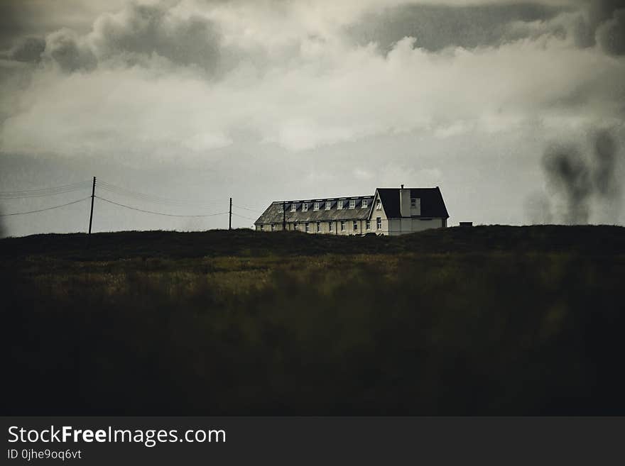 White Concrete House Under White Clouds