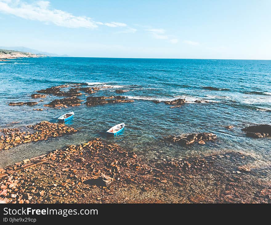 Two Blue Wooden Boats on Ocean Portrait