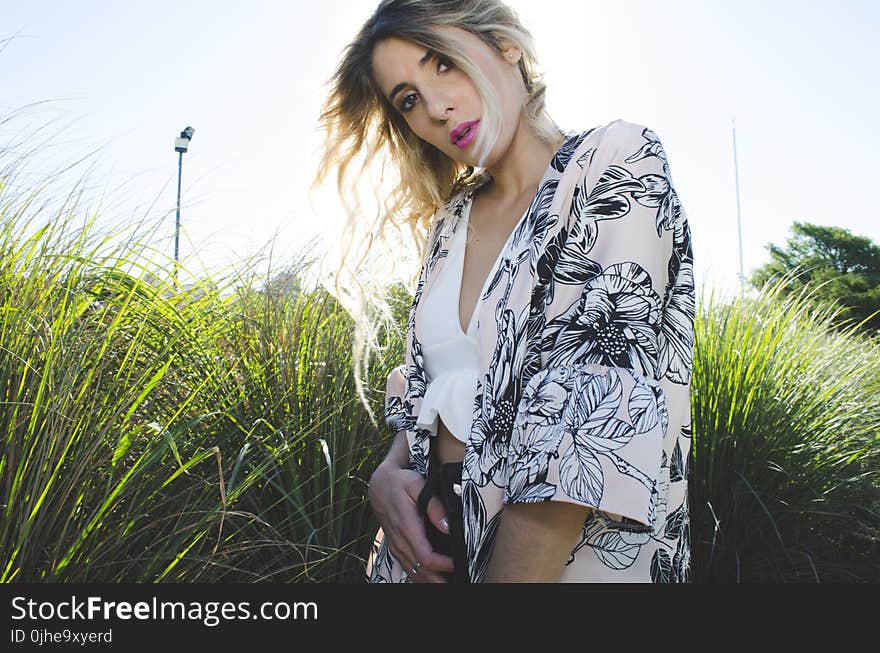 Woman Wearing White, Black, and Gray Floral Print Cardigan