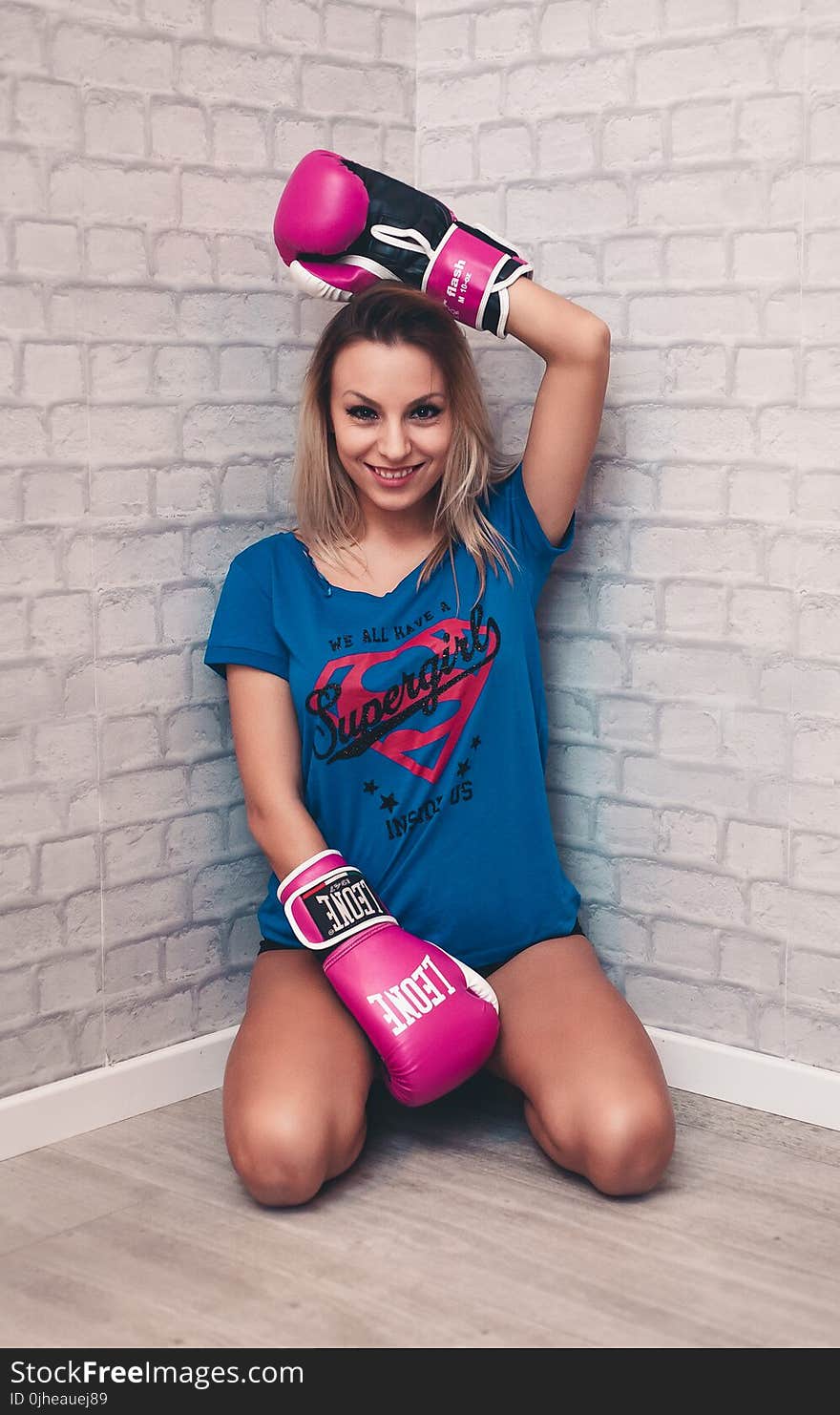 Woman Wearing Blue Crew-neck Shirt and Pink Boxing Gloves