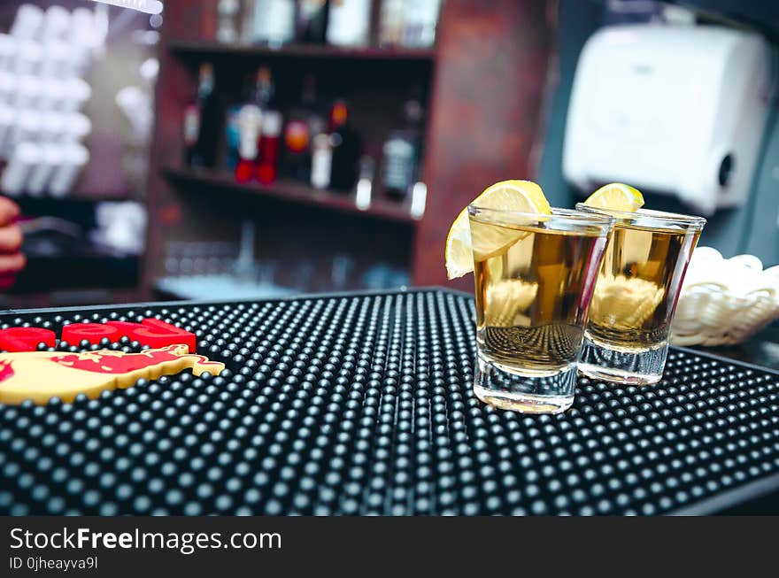 Two Clear Shot Glasses Filled With Alcohol