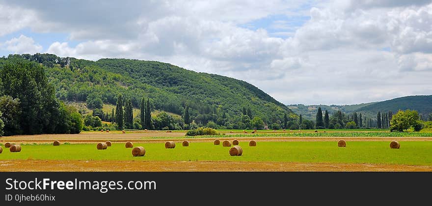 Panoramic Photograph of Haystacks on Field